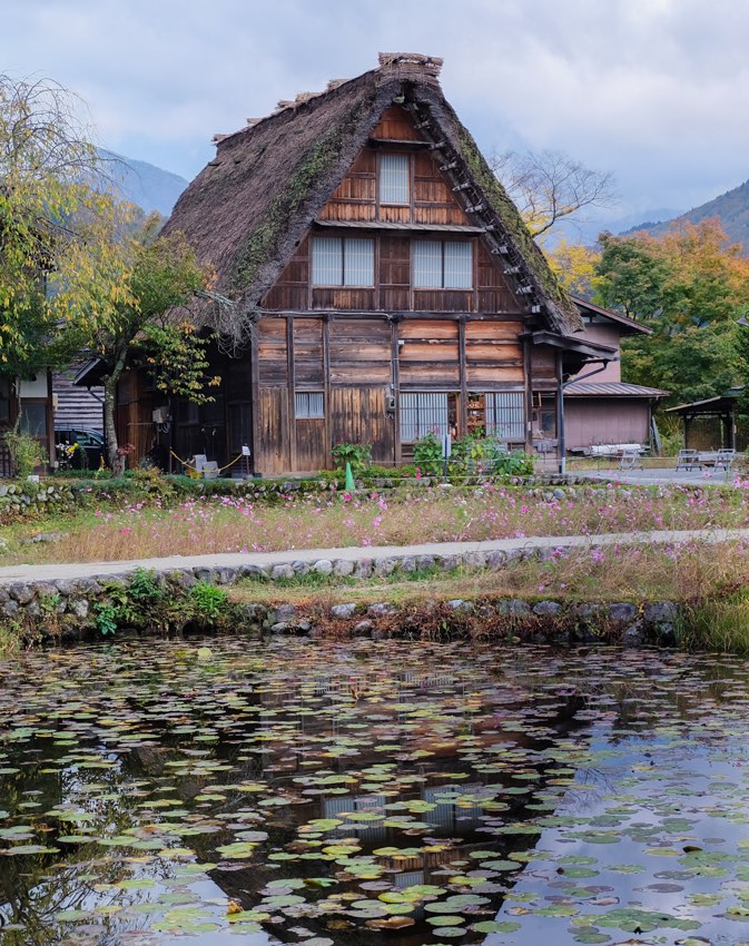 Altes Bauernhaus mit Spieglung im Teich im Dorf Shirakawa-go in Japan